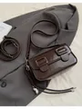 Minimalist dark brown glossy baguette bag with metal buckle and silver bean charm accent - Coffee With Pendant