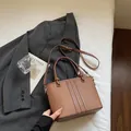 Brown vintage faux leather bucket bag with vertical stitching and round hardware - Brown