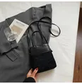 Minimalist black bucket bag with diamond quilted leather and suede paneling detail - Black