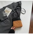 Small bucket bag with black leather and brown quilted suede contrast stitching - Brown