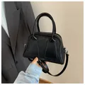 LUKADI black matte leather Boston bag with adjustable strap and branding - Black