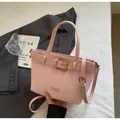 Pale pink faux leather bucket bag with gold buckle detail and adjustable shoulder strap - Standard / Pink