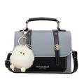 Gray and black saddle bag featuring cross-grain fabric and a white plush charm - Blue