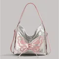 Silver metallic butterfly shoulder bag with pink bow accents and long strap - Pink