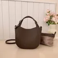 Dark brown pebble leather bucket bag with handle, crossbody strap, and inner pouch - Brown