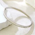 Elegant silver titanium steel bangle with shimmering crystal pavé in a modern design - Eternity White Zirconia Bangle / Steel