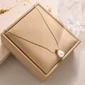 Detailed close-up of a white teardrop pearl pendant on a delicate gold chain necklace - Perfume Bottle Pearl Necklace (XL8006J) / Gold