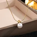 Macro detail of a single white pearl pendant on a gold snake chain necklace - Pearl Necklace (XL8005J) / Gold