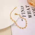 Detail of gold heart link bracelet with radial textures, lobster clasp and extension chain - Bracelet / Gold