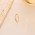 Close-up of a minimalist golden wavy titanium steel ring on a marble surface background - Size 5 / Thin Wave Style (JZ1013J) / Gold
