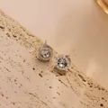 Close-up of silver titanium steel earrings with roman numerals and clear zircon stones - 6mm Roman Numeral Stud (Single) / Steel