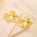 Macro shot of 18k gold flower earrings with pearls on a textured travertine stone - Polished Five-Petal Flower Artificial Pearl Stud (ED080) / Gold