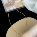 Exquisite 18K gold plated titanium necklace with three heart pendants on a velvet display - Triple Heart Necklace (XL8045J) / Gold