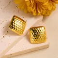 Detailed view of square gold earrings with hammered texture on a marble stone background - Hammered Square Style (ED223)