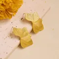 Macro detail of gold leaf stud earrings with linear texture and elegant petal design - Striped Leaf (ED238) / Gold