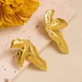 Macro detail of golden leaf-shaped titanium steel earrings with fine vein textures - Triple Leaf Cluster (ED239) / Gold