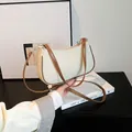 Chic cream canvas and brown leather crescent underarm bag with adjustable strap - White