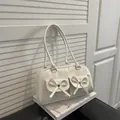 Elegant white PU leather shoulder tote bag with decorative bow-studded flap pockets - White