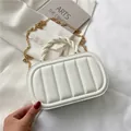 Elegant white quilted handbag with gold chain strap and braided handle on minimalist background - White