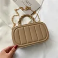 Khaki quilted handbag with gold chain strap and woven handle in high-fashion flat lay - Khaki