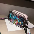 Pink graffiti camera bag with colorful woven strap and street art style prints - Pink