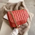 Coral quilted crossbody bag with gold chain strap and elegant diamond stitch finish - Red