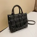 Chic black quilted handbag with white contrast stitching and decorative chunky chain strap - Black