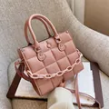 Pink quilted PU leather crossbody bag with chunky plastic chain on grey sofa - Pink