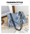 Light blue snakeskin textured envelope crossbody bag with a chunky dark grey chain strap - Blue