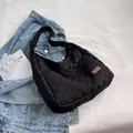 Minimalist black woven hobo shoulder bag with brown leather label detail - Black