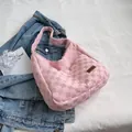 Pink checkerboard tote bag with woven texture and a wide matching shoulder strap - Pink