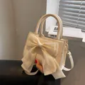 Creamy white small crossbody bag with a large mesh bow and dual handles - Off White