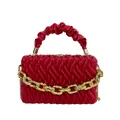 Chic red quilted leather handbag featuring a thick gold chain and crossbody strap - Red