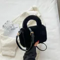 Chic black plush faux fur handbag with adjustable leather strap and gold hardware accents - Black
