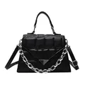 Chic black trapezoid handbag with bubble quilted texture and metallic chain detail - Black