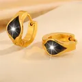 Detail of gold hoop earrings with teardrop black zircon and matte steel finish - Teardrop Earrings / Black