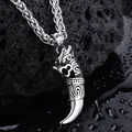 Close-up of retro dragon tooth pendant with textured scales on black volcanic rock - Wolf Tooth Pendant (Keel Chain)