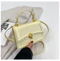 Chic cream beige small square handbag with golden double-ring twist lock and top handle - Yellow