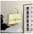 Chic pistachio green square handbag with gold interlocking buckle and top handle - Green
