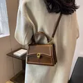 Dark brown leather top-handle crossbody bag with elegant gold chain buckle detail - Khaki