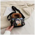 Black canvas crossbody bag with cartoon Girl with a Pearl Earring print and brown handle - Girl with a Pearl Earring Illustration / Black