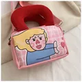 Pink canvas crossbody bag with red corduroy handles and artistic cartoon print - Pink