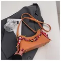 Orange moon-shaped crossbody bag with lychee texture and silk scarf wrapped handle - Orange
