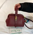 Vintage burgundy lychee texture handbag with golden kiss-lock closure and leather strap - Red