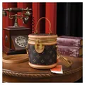 Vintage brown leather cylinder bucket bag with classic pattern and top handle strap - Dark Brown