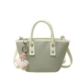 Chic light green woven PU leather bucket bag with top handles and plush pendant - Green