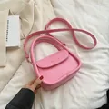 Pink minimalist crossbody bag with round flap and FASHION & BAGS metal text logo - Pink