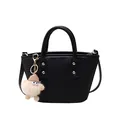 Black woven bucket bag with top handles, crossbody strap and plush doll charm - Black