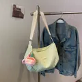Mint green pleated cloud crossbody bag with strawberry plush charm and adjustable strap - Green