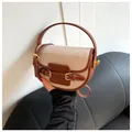 Classic beige canvas saddle bag with brown leather trim and gold metal buckle detail - Brown